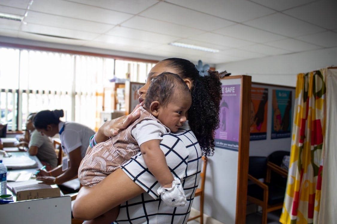 Mother soothes baby after vaccination